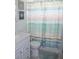 Clean bathroom with white vanity and blue shower curtain at 4460 95Th N Ave # 1, Pinellas Park, FL 33782