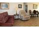 Living room with hardwood floors, comfortable seating, and a view of the dining area at 4460 95Th N Ave # 1, Pinellas Park, FL 33782