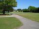 Scenic golf course path with lush green grass and mature trees at 4460 95Th N Ave # 1, Pinellas Park, FL 33782