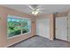 Bedroom with ceiling fan and large window at 2857 Brewster Rd, North Port, FL 34288