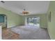 Spacious living room with carpet and sliding doors to backyard at 2857 Brewster Rd, North Port, FL 34288
