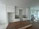 White kitchen with white cabinetry, marble backsplash, and under-mount sink at 1302 E Kay St # 1, Tampa, FL 33602
