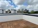 Spacious rooftop deck with wood tile flooring and city views at 1302 E Kay St # 1, Tampa, FL 33602