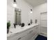 Modern bathroom with double vanity, marble countertops, and a walk-in shower at 1302 E Kay St # 1, Tampa, FL 33602