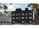 Modern three-story townhomes with dark brick exterior at 1302 E Kay St # 1, Tampa, FL 33602