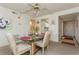 Condo dining room with a glass-top table and four chairs, near entry at 12760 Indian Rocks Rd # 1071, Largo, FL 33774