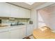 Updated kitchen with white cabinets, dishwasher, and a small dining area at 12760 Indian Rocks Rd # 1071, Largo, FL 33774