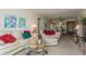 Spacious living room with light beige couch and ottoman, coffee table, and TV stand at 12760 Indian Rocks Rd # 1071, Largo, FL 33774
