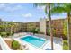 Refreshing community pool with surrounding lounge chairs and palm trees at 12760 Indian Rocks Rd # 1071, Largo, FL 33774