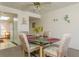 Charming dining room with glass-top table, four chairs, and ceiling fan at 12760 Indian Rocks Rd # 1071, Largo, FL 33774