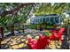 Wooden deck with red Adirondack chairs, ideal for enjoying the view at 10931 Clara Ln, St Petersburg, FL 33708