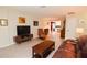 Living room with leather furniture, wood coffee table, and view of kitchen at 10931 Clara Ln, St Petersburg, FL 33708