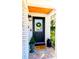 Black front door with wreath and decorative mat at 10931 Clara Ln, St Petersburg, FL 33708