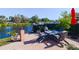 Waterfront patio with fire pit and comfortable seating at 10931 Clara Ln, St Petersburg, FL 33708
