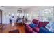 Sunroom with water views, comfortable seating area, and hardwood floors at 10931 Clara Ln, St Petersburg, FL 33708