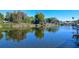 Peaceful waterfront view with lush vegetation and houses at 10931 Clara Ln, St Petersburg, FL 33708