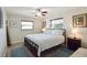 Spacious main bedroom with king-size bed and ceiling fan at 10931 Clara Ln, St Petersburg, FL 33708