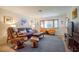 Bright living room with comfortable seating and large windows at 10931 Clara Ln, St Petersburg, FL 33708