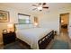 Main bedroom with king bed, ceiling fan, and access to hallway at 10931 Clara Ln, St Petersburg, FL 33708