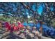 Waterfront deck with red Adirondack chairs and lake views at 10931 Clara Ln, St Petersburg, FL 33708