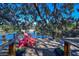 Relaxing waterfront deck with red Adirondack chairs at 10931 Clara Ln, St Petersburg, FL 33708