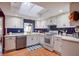 White kitchen with blue tile backsplash and stainless steel appliances at 10931 Clara Ln, St Petersburg, FL 33708