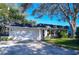 Brick ranch home with attached garage and mature landscaping at 10931 Clara Ln, St Petersburg, FL 33708