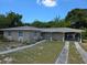 Newly renovated home with carport and landscaping at 491 Edgehill Ave, Spring Hill, FL 34606