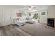 Living room with L-shaped sofa, fireplace, and hardwood floors at 2101 Fox Chase Blvd # 106, Palm Harbor, FL 34683