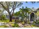 Two story building with gray siding, surrounded by lush landscaping and walkways at 2101 Fox Chase Blvd # 106, Palm Harbor, FL 34683