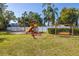playground with swings, climbing structures, and benches at 2101 Fox Chase Blvd # 106, Palm Harbor, FL 34683
