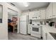 Bright kitchen with white cabinets and views of living room at 2101 Fox Chase Blvd # 106, Palm Harbor, FL 34683