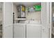 Convenient laundry room with washer, dryer, and shelving at 2101 Fox Chase Blvd # 106, Palm Harbor, FL 34683