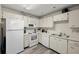 Well-equipped kitchen with white cabinets and ample counter space at 2101 Fox Chase Blvd # 106, Palm Harbor, FL 34683