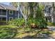 Landscaped courtyard with a wooden bench, surrounded by two story buildings at 2101 Fox Chase Blvd # 106, Palm Harbor, FL 34683