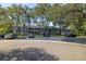 Parking area in front of two story building with many trees at 2101 Fox Chase Blvd # 106, Palm Harbor, FL 34683