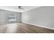 Bright bedroom with wood-look floors and ceiling fan at 8378 Gibralter St, Spring Hill, FL 34608