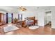Main bedroom with hardwood floors, ceiling fan, and access to hallway at 8378 Gibralter St, Spring Hill, FL 34608