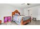 Bright bedroom with wood flooring, double doors to bathroom, and a ceiling fan at 8378 Gibralter St, Spring Hill, FL 34608