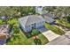 Two-story house with a three-car garage and manicured lawn, located near a lake at 8378 Gibralter St, Spring Hill, FL 34608