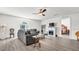 Living room with gray sofa, ceiling fan, and fireplace at 8378 Gibralter St, Spring Hill, FL 34608