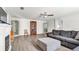 Living room with gray sofas, ceiling fan and hardwood floors at 8378 Gibralter St, Spring Hill, FL 34608
