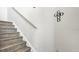 Modern staircase with wood-look laminate treads and a simple handrail at 8378 Gibralter St, Spring Hill, FL 34608