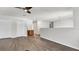 Large living room with double closets, wood-look flooring and ceiling fan at 8378 Gibralter St, Spring Hill, FL 34608