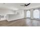 Bright and airy living area with two arched windows and wood-look floors at 8378 Gibralter St, Spring Hill, FL 34608