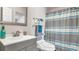 Clean bathroom with gray vanity, shower, and striped curtain at 8378 Gibralter St, Spring Hill, FL 34608