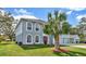 Two-story house with gray siding, red door, and three-car garage at 8378 Gibralter St, Spring Hill, FL 34608