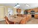 Kitchen features an island, wood cabinets, and a dining area at 8378 Gibralter St, Spring Hill, FL 34608