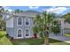 Two-story house with gray siding, three-car garage, and red front door at 8378 Gibralter St, Spring Hill, FL 34608