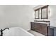 Bathroom with double vanity and a large bathtub at 8378 Gibralter St, Spring Hill, FL 34608